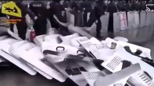 Police in Ukraine throw down shields stand with The People